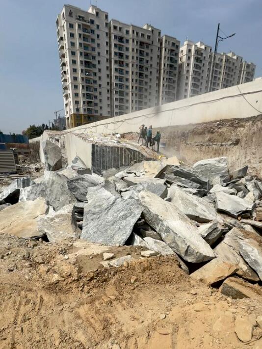 Concrete demolition debris pile beside residential towers under construction