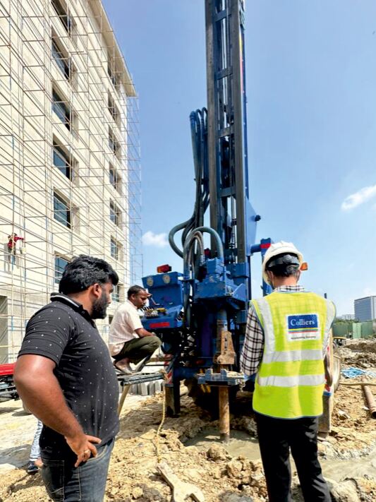 Micropiling rig with site engineers on a restricted-access foundation site