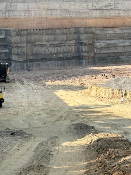 Sheet piling excavation support wall alongside a water-filled trench