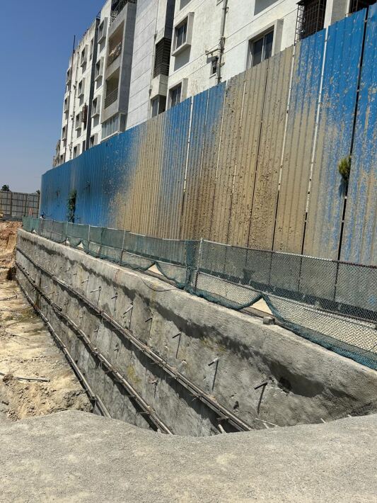 Cross-section of layered soil and rock strata exposed during a geotechnical excavation in Bengaluru